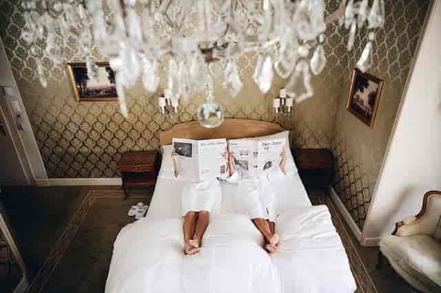 Luxury boutique hotel room with chandelier for VIP corporate event and travel booking.