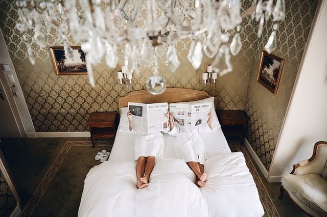 Luxury boutique hotel room with chandelier for VIP corporate event and travel booking.