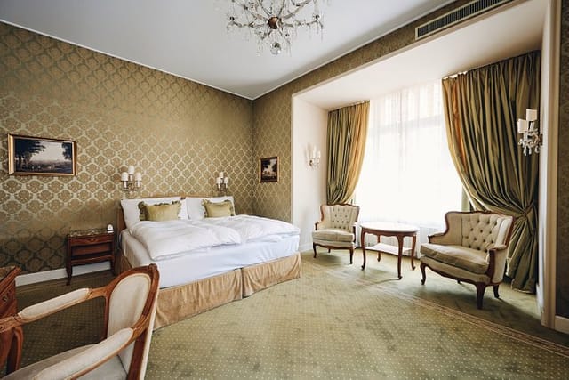 Upscale Hotel Europe guest room with seating area for VIP speaker accommodation and event blocks.
