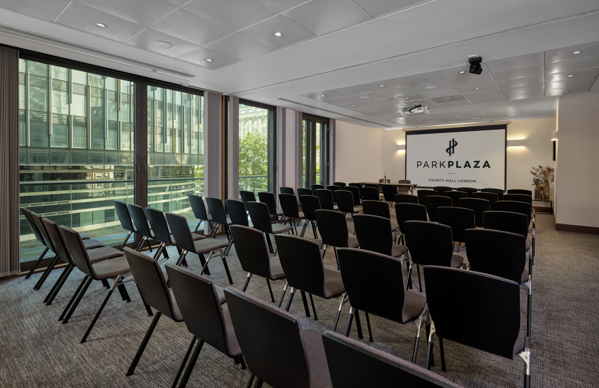 Putney and Westminster Suite: modern meeting room with black chairs for corporate events.