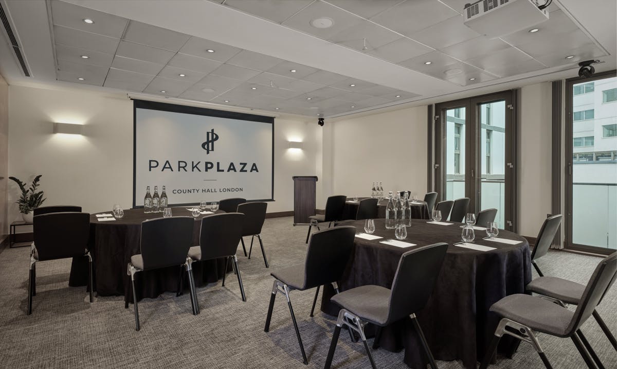 Battersea Suite meeting room with round tables, ideal for conferences and workshops.