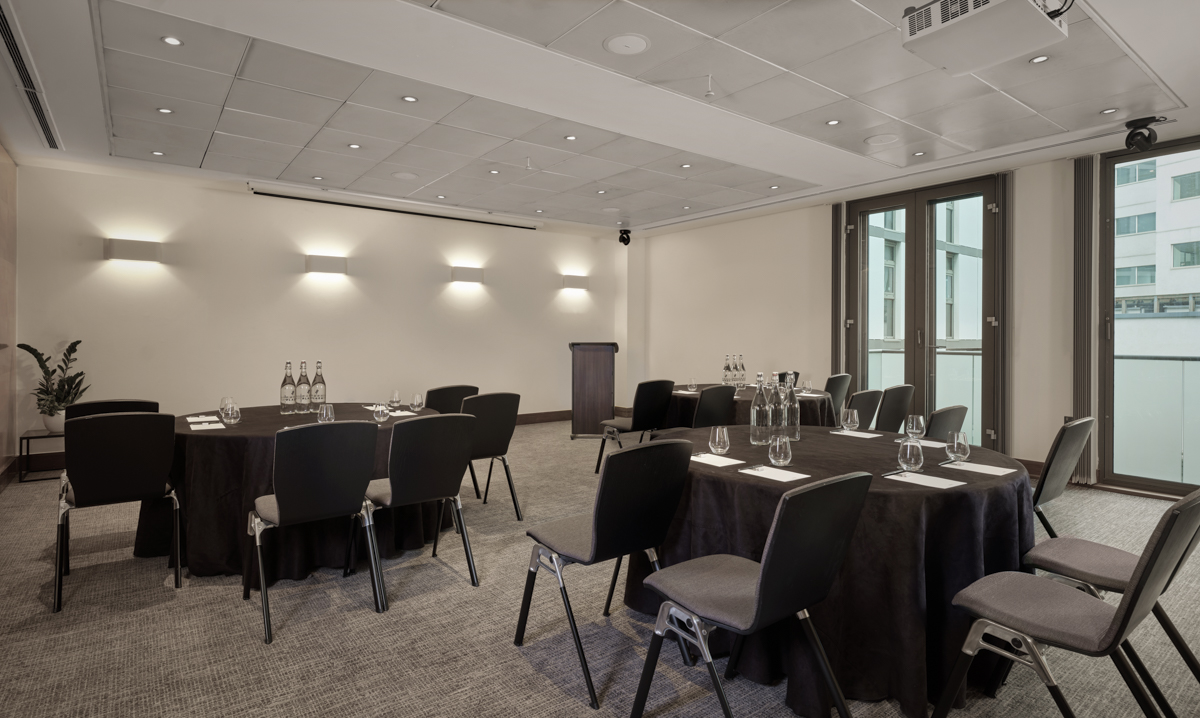 Battersea Suite meeting room with round tables, ideal for workshops and presentations.
