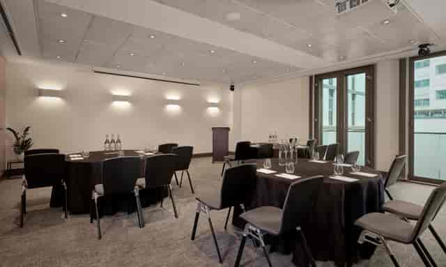 Meeting room at Park Plaza County Hall with round tables for corporate events.