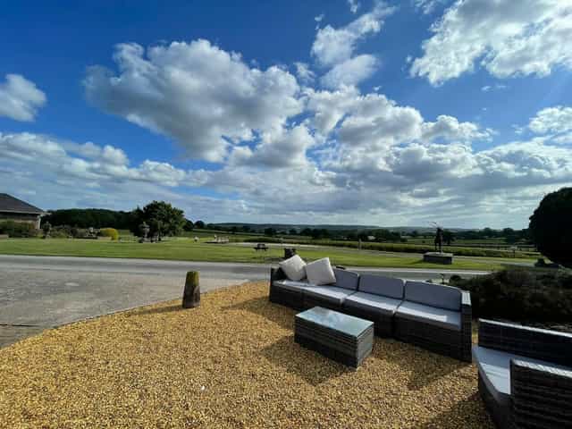 Barn conversion venue with scenic views, ideal for corporate retreats and outdoor networking events.