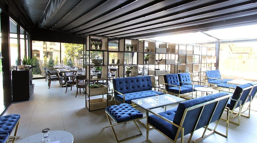 Lokkum Bar & Grill lounge with luxe seating and retractable roof for corporate events and receptions. - Banner