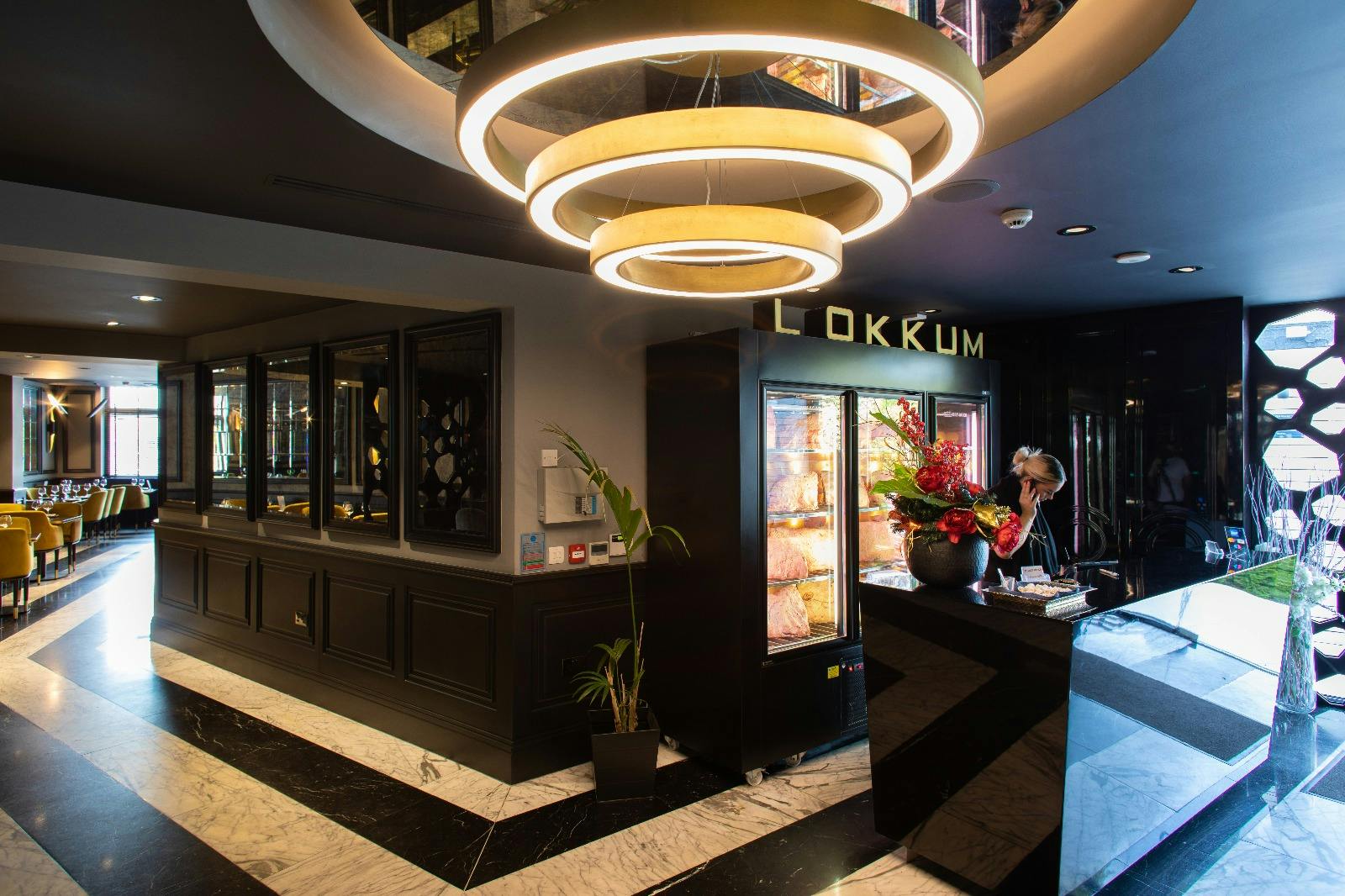 Modern restaurant foyer at Lokkum Bar & Grill for upscale corporate event and VIP welcome reception. - Banner