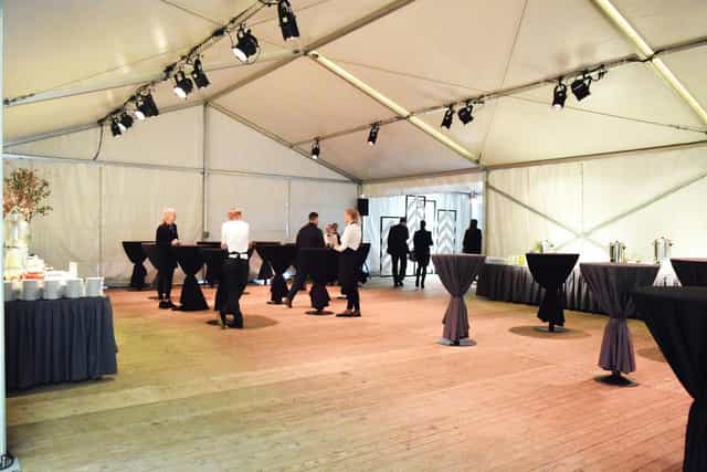 Cocktail reception marquee at H 2 O 6 Kvartāls with high-top tables for corporate networking events.