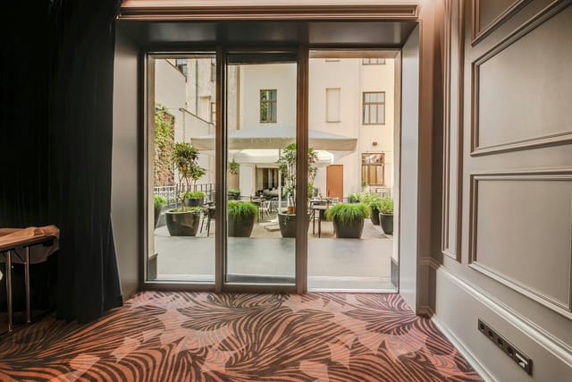 Upscale Grand Poet Hotel restaurant patio for business conferences and networking events.