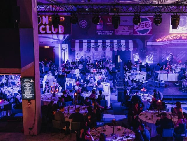 Nebula gala dinner with banquet seating and immersive lighting for corporate events.