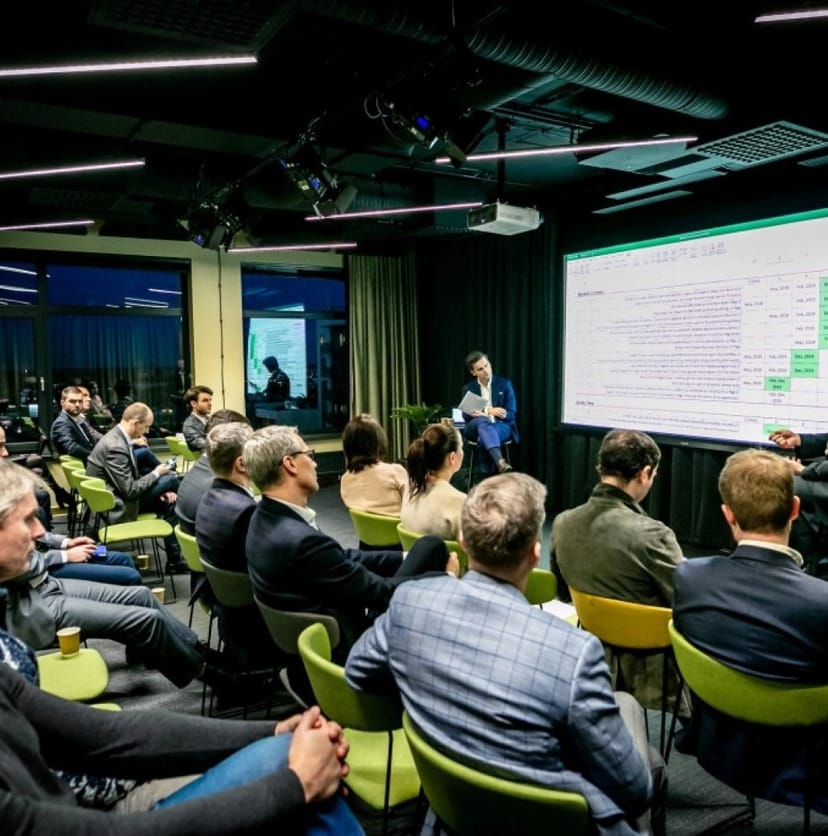 Minox boardroom theatre-style corporate briefing, high-stakes presentation.