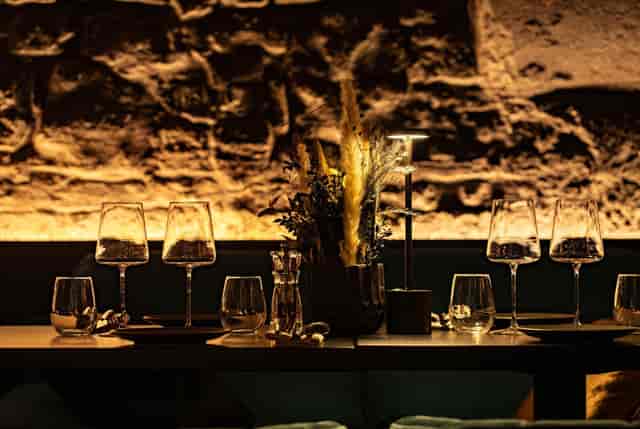Intimate Harper Woolf bar with textured stonework for high-end private dining events.