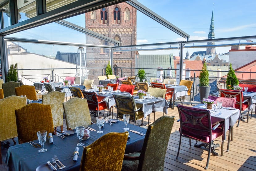 Outdoor rooftop bar in Riga with retractable glass roof for corporate events and private dining.