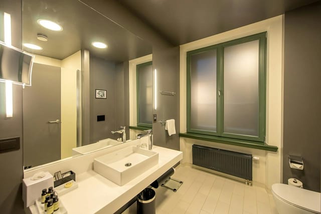Modern hotel bathroom with spa aesthetic for corporate travel and business event lodging.