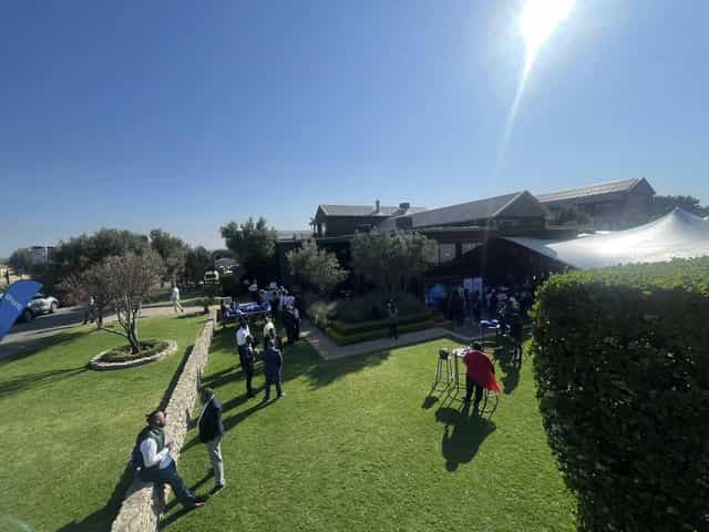 Corporate breakout session on Langhams estate lawn, outdoor business event venue.
