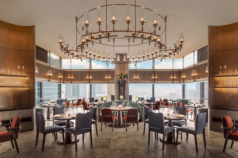 Upscale restaurant venue with chandelier and city views for corporate networking and private dining.
