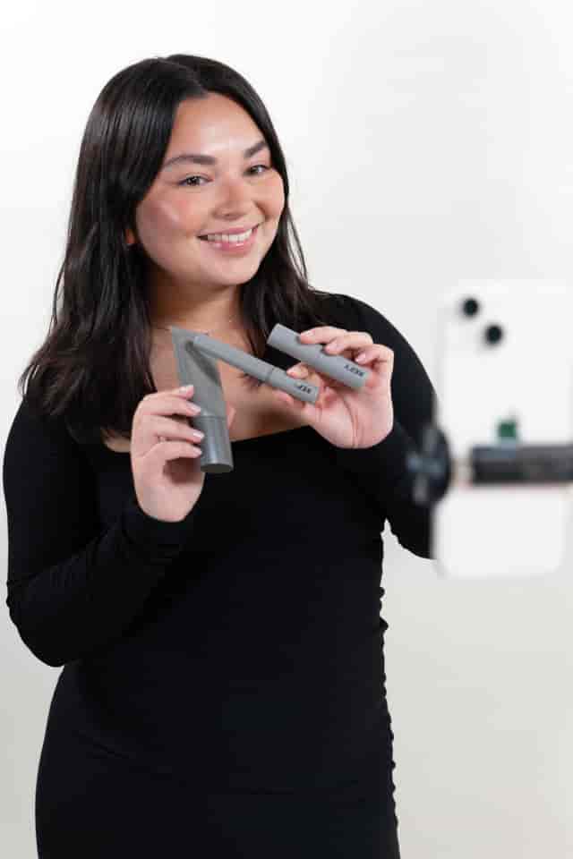 Confident presenter demonstrating innovative products in studio space event.