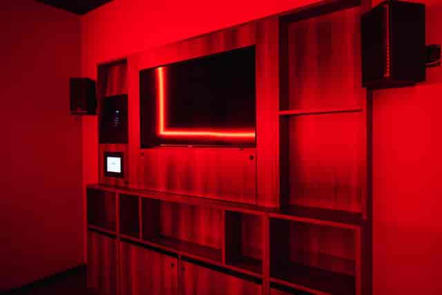 Moyagi private karaoke room with red ambient lighting for VIP event or corporate meeting.