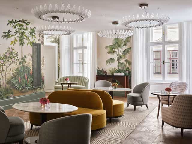 Salon Aurelie boutique meeting space with botanical murals for VIP events and networking.
