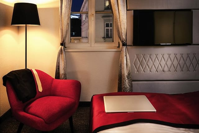 Mercure Boutique Hotel Vienna suite: laptop and suit, perfect for business travel and events.