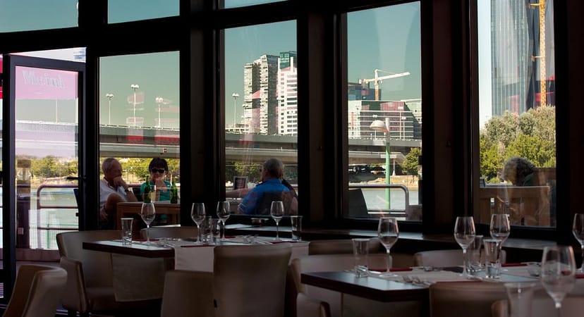 Modern restaurant venue with window views, perfect for VIP dinners and corporate networking.