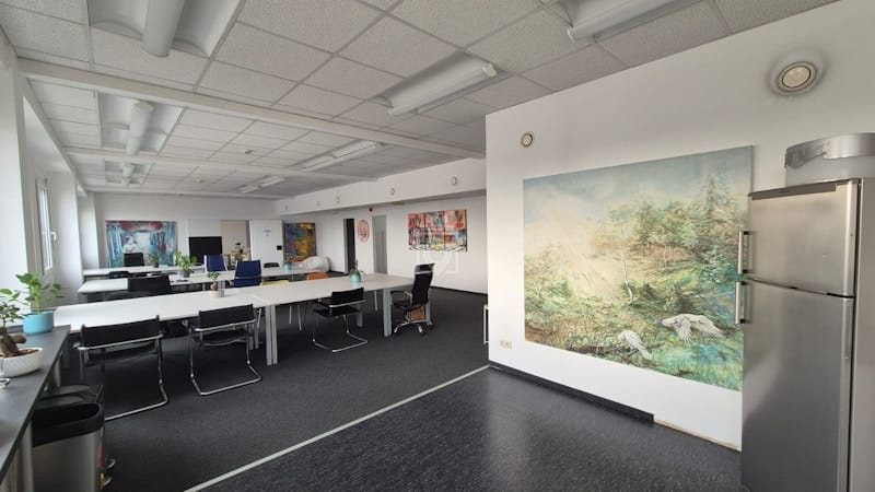 Shared Atelier multi-purpose workshop space with long tables for collaborative team events.