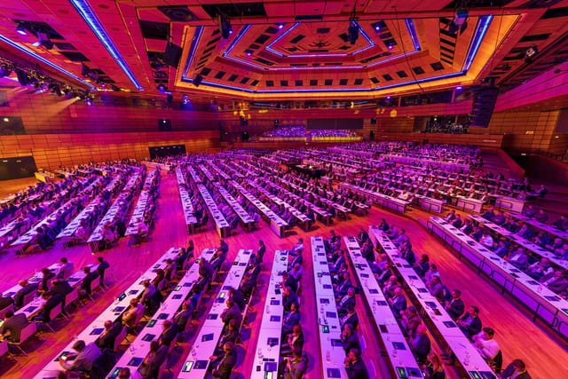 Classroom-style plenary session in Austria Center Vienna ballroom for professional conferences.