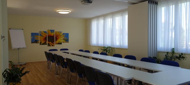 U-shape boardroom at d'FarbeSPACE with fluorescent lighting for budget meetings and conferences.