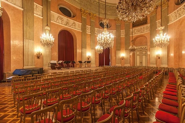 Theater-style Rosenkavalier Saal with chandeliers for formal concert or conference venue hire.