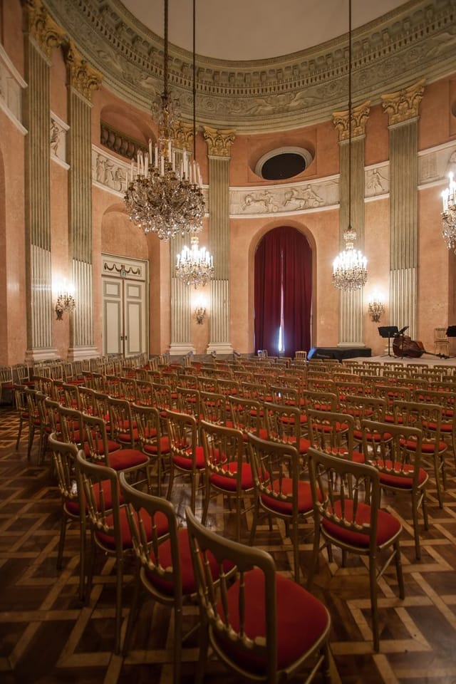 Theatre-style setup in Palais Auersperg historic ballroom for keynote and recital events.