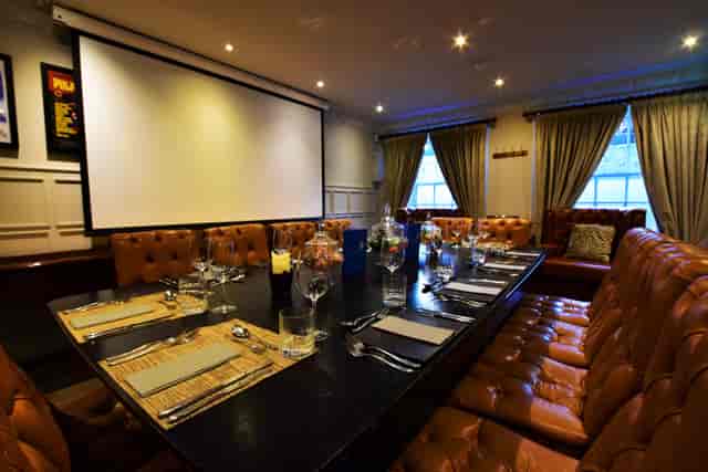 Private dining room with leather booths, ideal for corporate dinners and workshops.