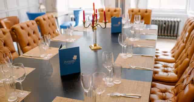 Badger & Co. private dining room with tufted leather seating for VIP dinners and executive meetings.
