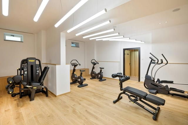Modern hotel fitness center at Hotel Maximilian for corporate wellness and business travel.