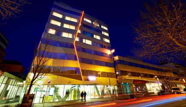 Modern Simm's Hotel exterior, street-level entrance for corporate group events and travel.