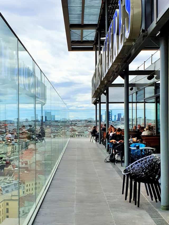 Rooftop cafe with panoramic skyline views for VIP cocktail receptions and networking mixers.