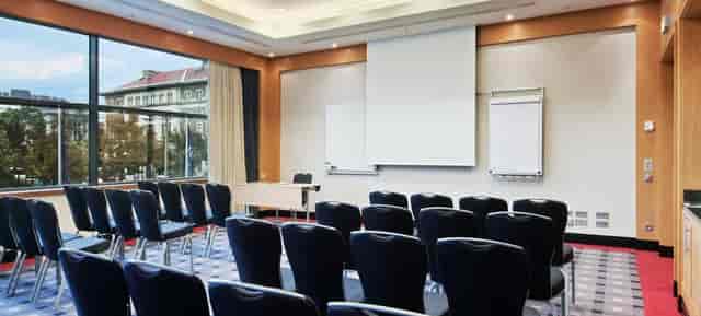 Theater-style banquet hall at Hilton Vienna Park with natural light for professional conferences.
