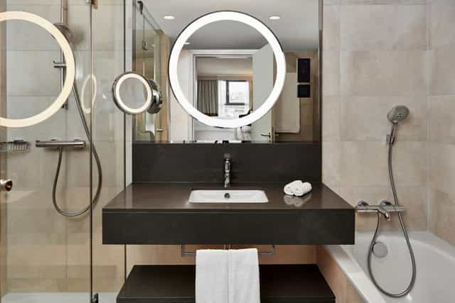 Upscale Hilton Vienna Park hotel bathroom for corporate events and VIP guest amenities.