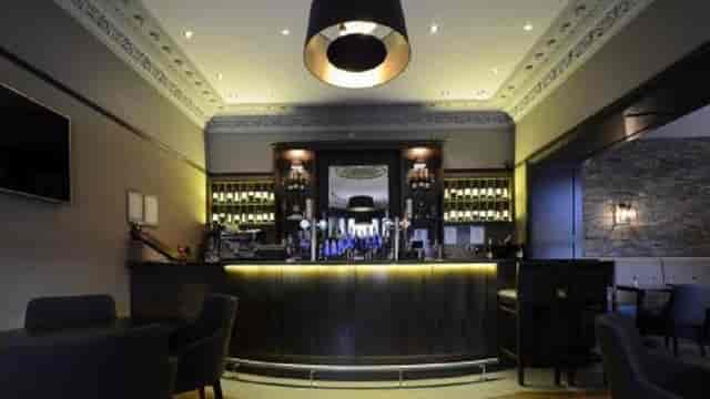 Sophisticated hotel bar with warm lighting for VIP networking and cocktail reception events.