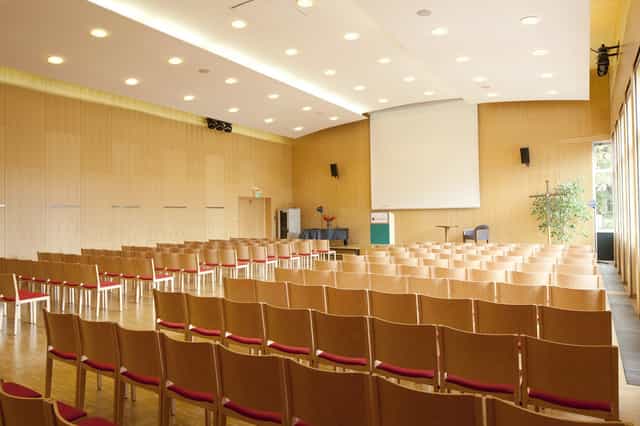 Theater-style auditorium at Kardinal König Haus for corporate presentations and academic lectures.