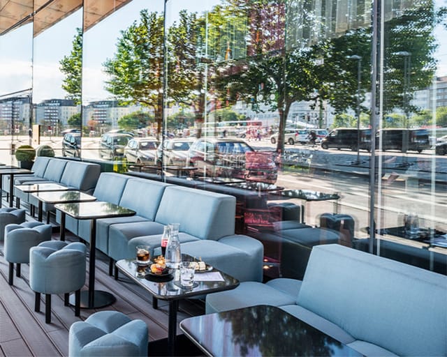 Sleek SO/ Vienna lounge with floor-to-ceiling windows, ideal for networking events and conferences.