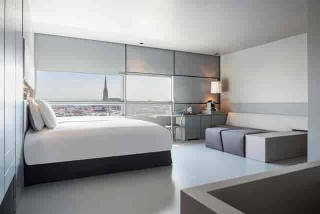 Modern minimalist hotel room at SO/ Vienna with skyline view for corporate events and luxury stays.