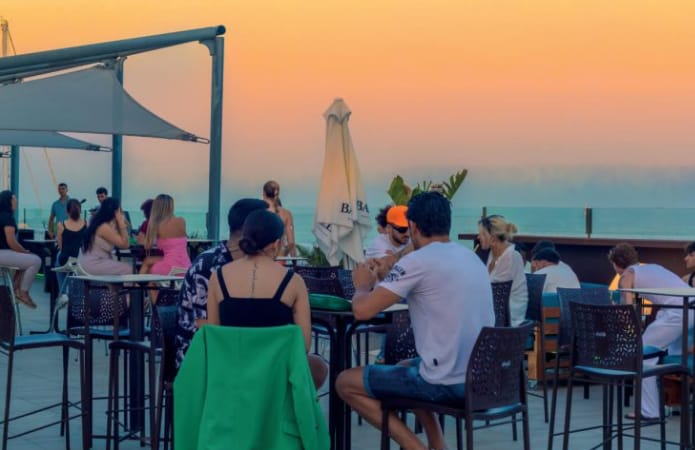 Sunset rooftop networking event at GO Beach Club Barcelona with lounge seating.