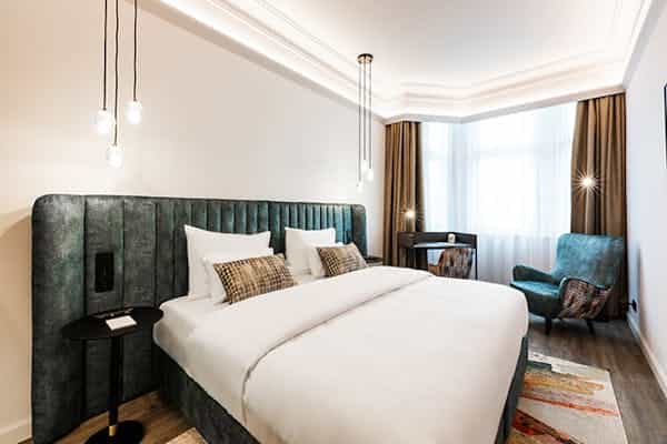 Modern hotel room with workstation for VIP business travel and corporate event accommodation.