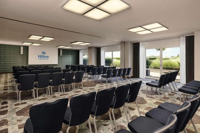 Hilton Vienna Waterfront theater-style meeting room for corporate events and professional training.