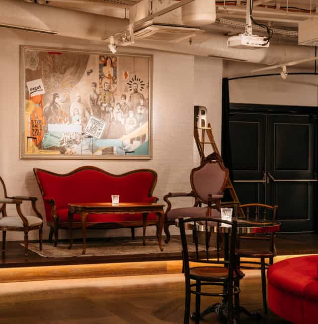Ruby Lissi Hotel eclectic lounge with red sofa for networking and VIP event hosting.