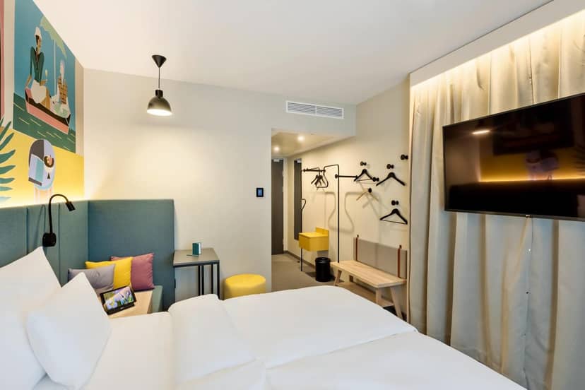 Modern Spark by Hilton Vienna room with functional seating for business travel and conferences.
