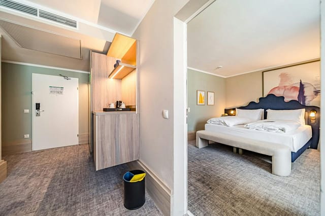 Modern guest room at voco Vienna Prater with workspace, ideal for business travel and conferences.