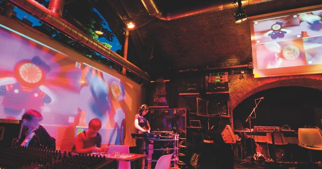 Industrial-chic lounge venue with projection mapping for corporate experiential events.