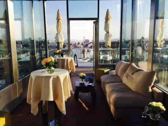 Glass-enclosed rooftop lounge at DO & CO Vienna for intimate networking and VIP events.
