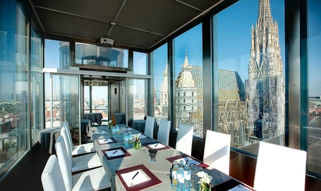 Luxury boardroom at DO & CO Hotel Vienna with iconic city view for executive retreats and meetings.