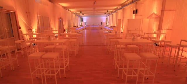 Spectacula event space with high-top tables for networking receptions and cocktail hours.